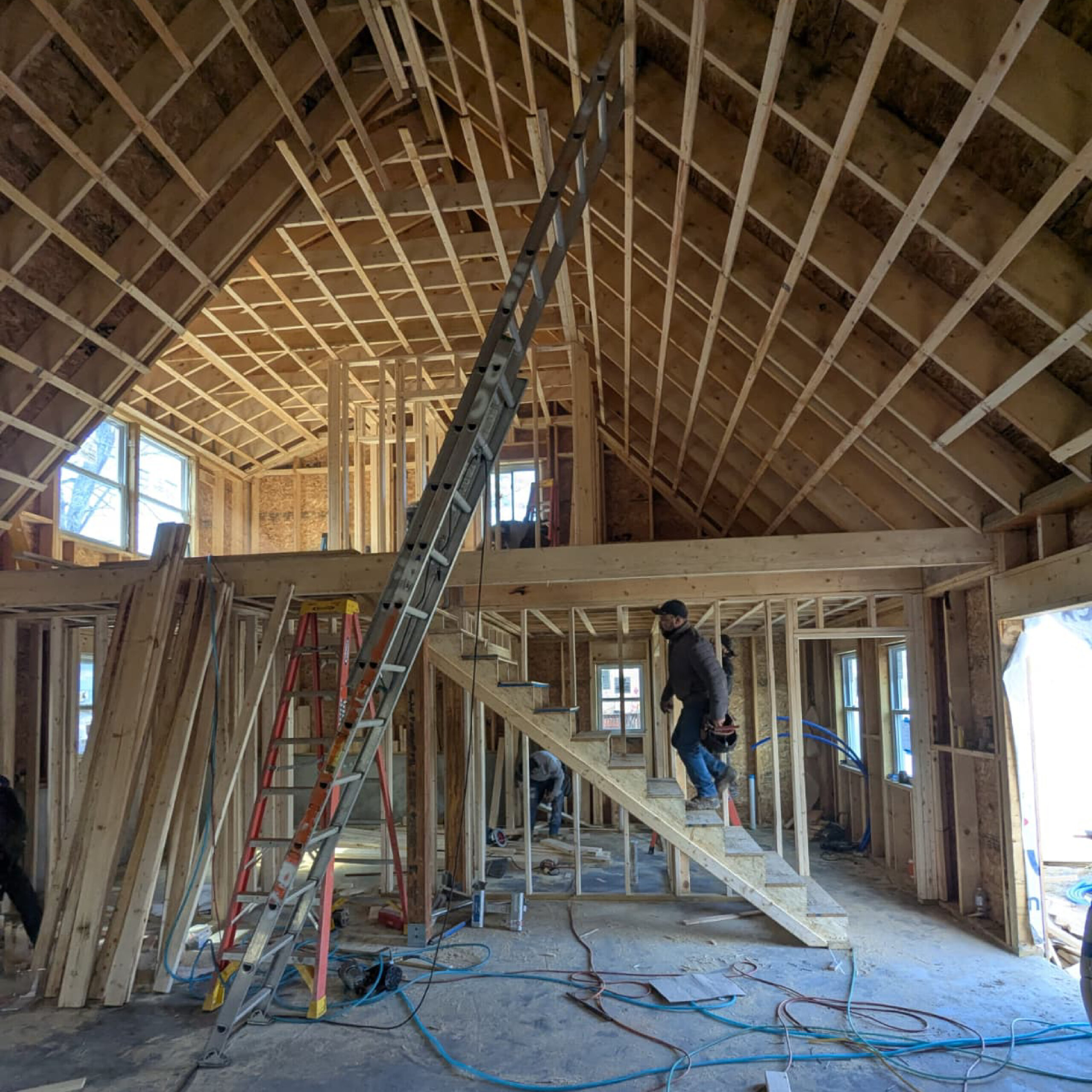 Open-concept residential framing and staircase construction by Family Realty Holdings