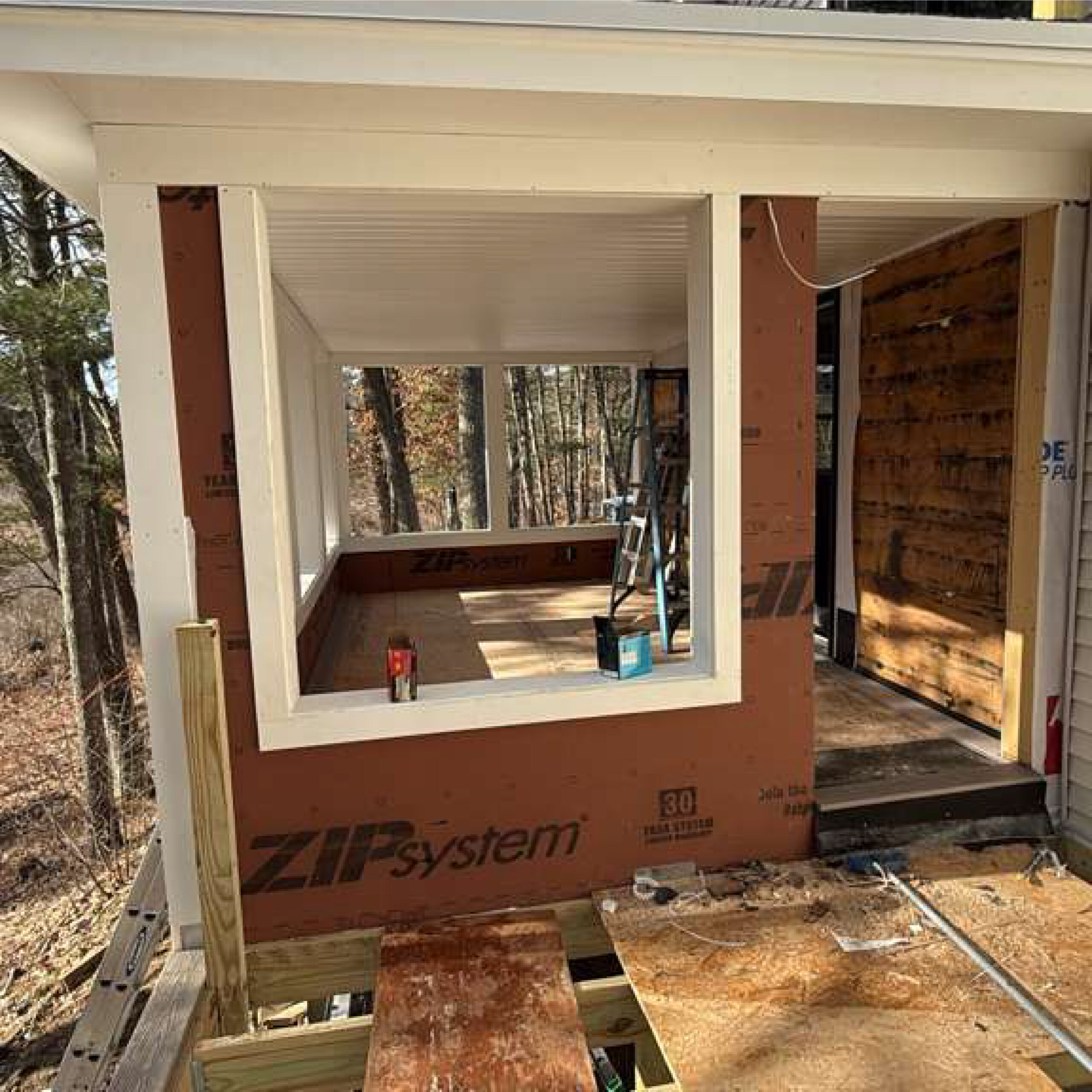 Residential construction detail featuring framed window opening by Family Realty Holdings
