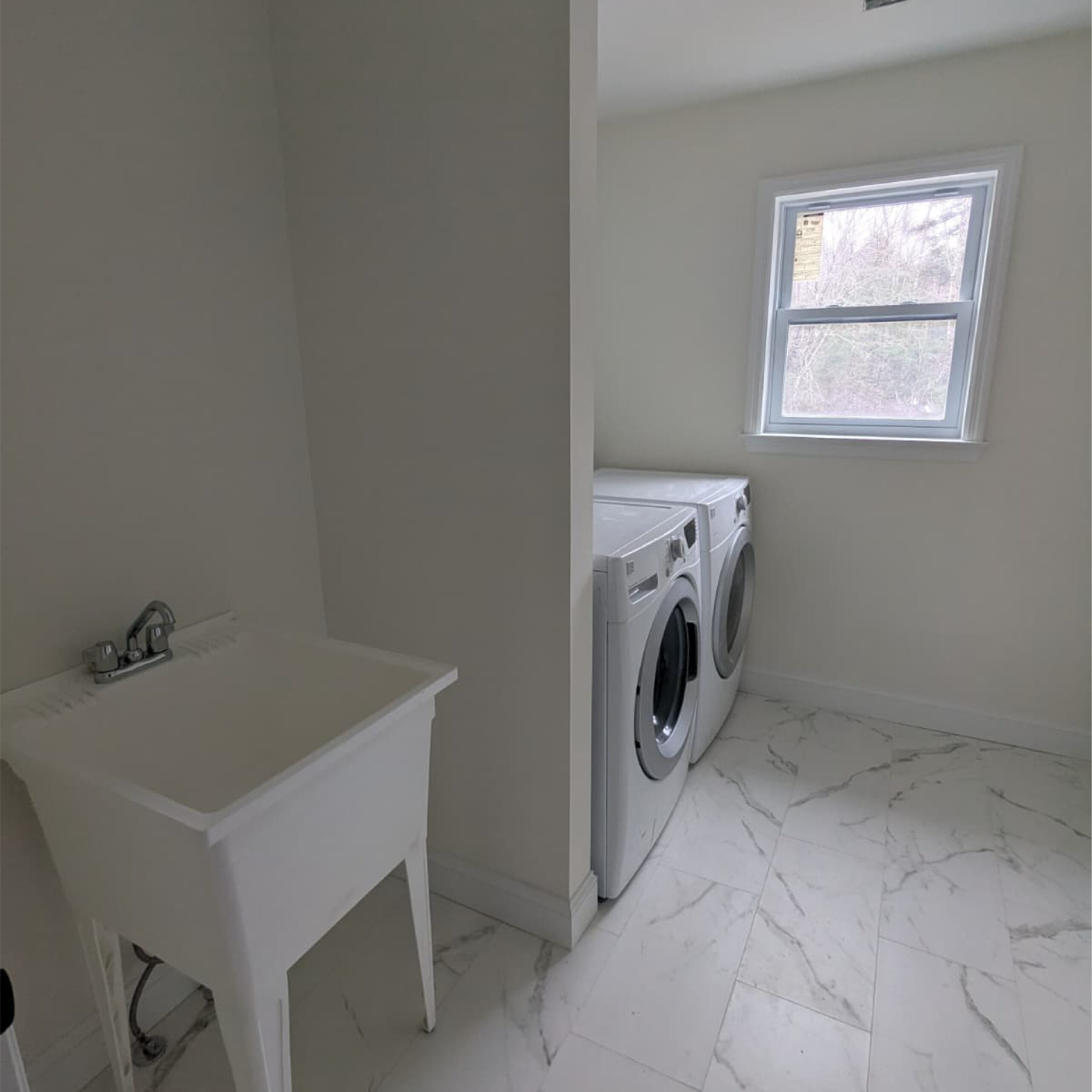 Bright laundry room interior designed by Family Realty Holdings