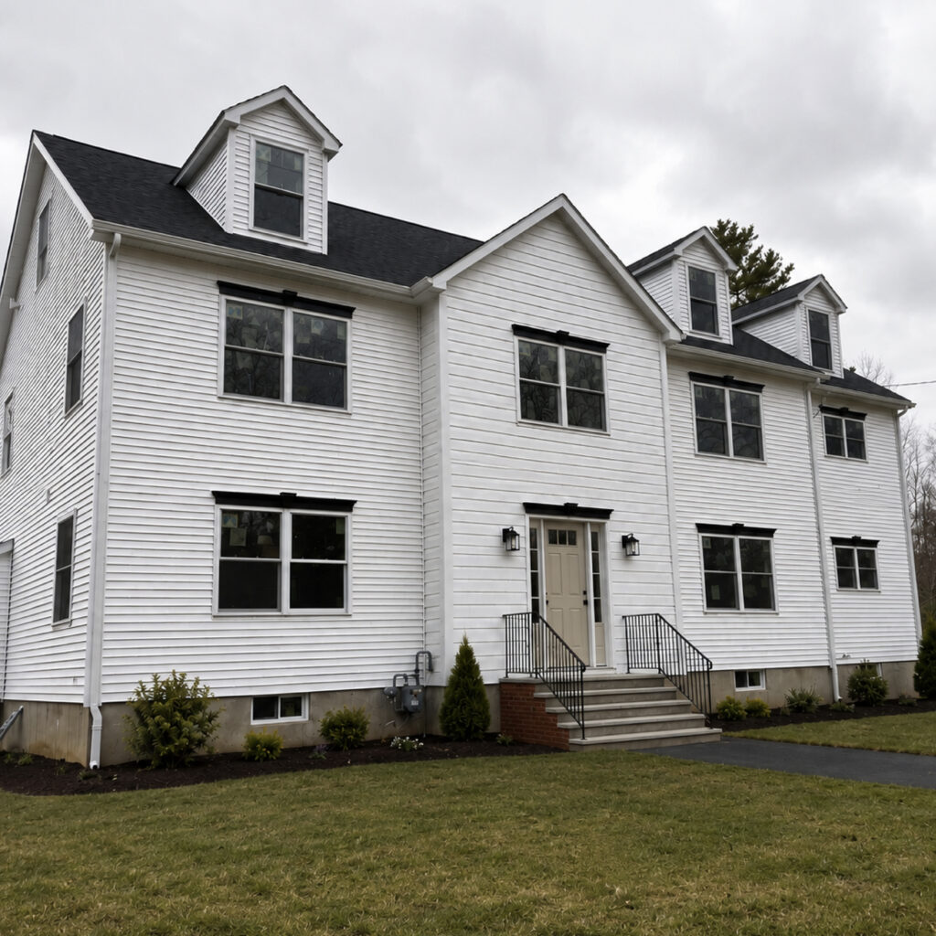 Family Realty Holdings Westford House exterior featuring completed multi-family residential development with modern farmhouse architecture